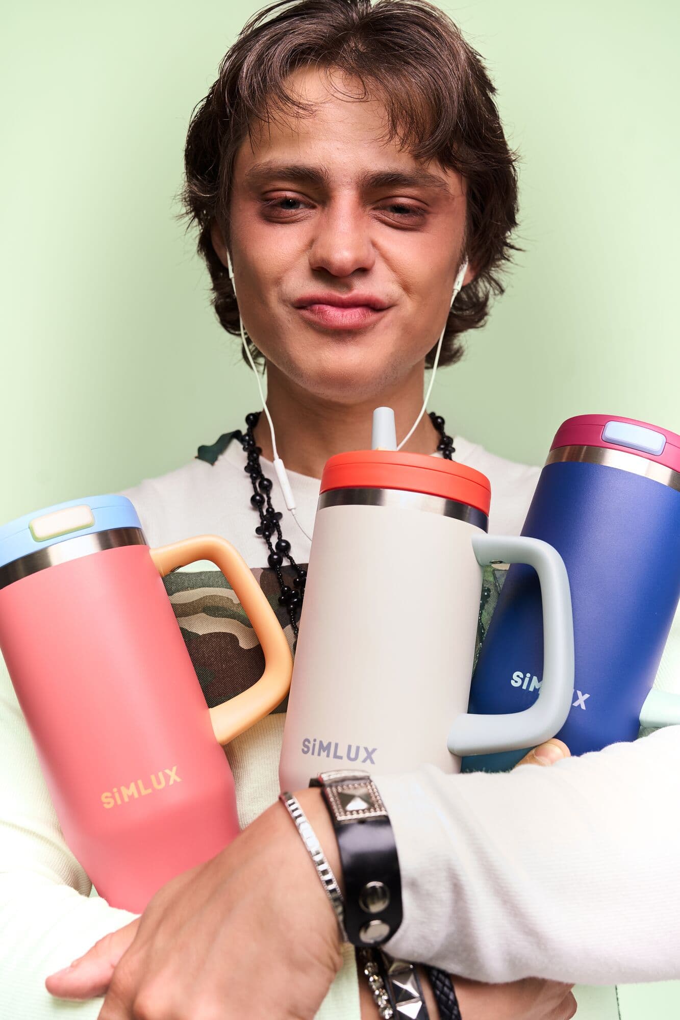 Model smiling with three 40oz tumblers