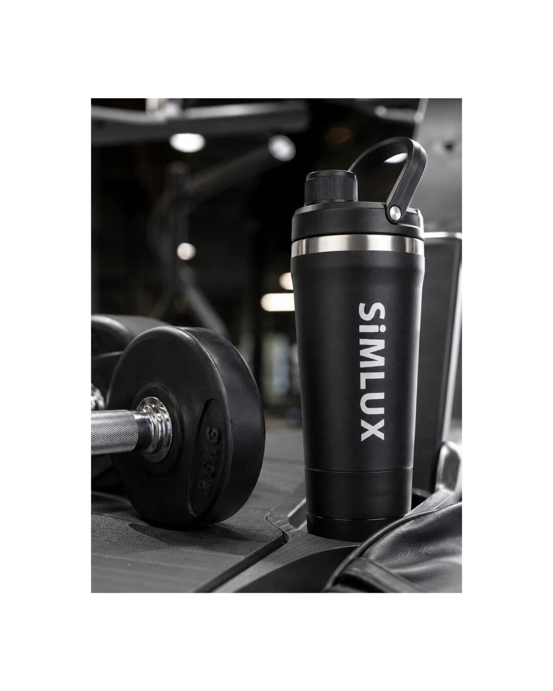 Black shaker on a gym bench beside a dumbbell